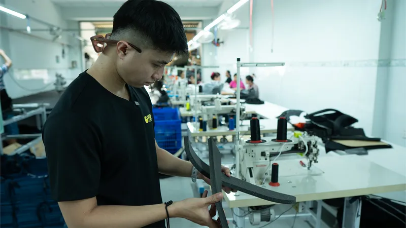 Yuzi checking strap foam at the sewing workshop